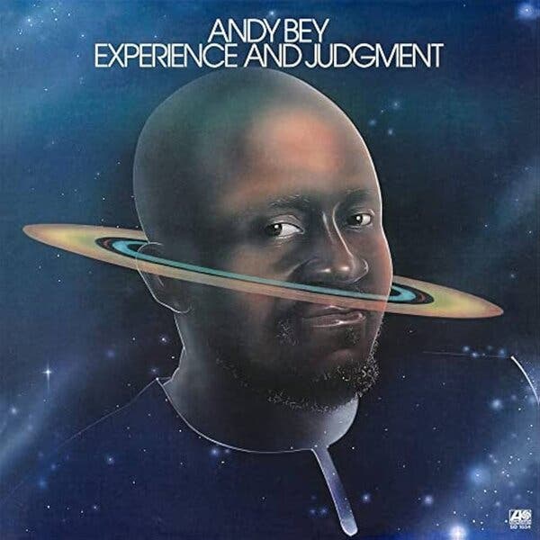 The cover of the album is dominated by a close-up photo/illustration of the singer in a starry setting, his bald head encircled by rings, like those around the planet Saturn. 
